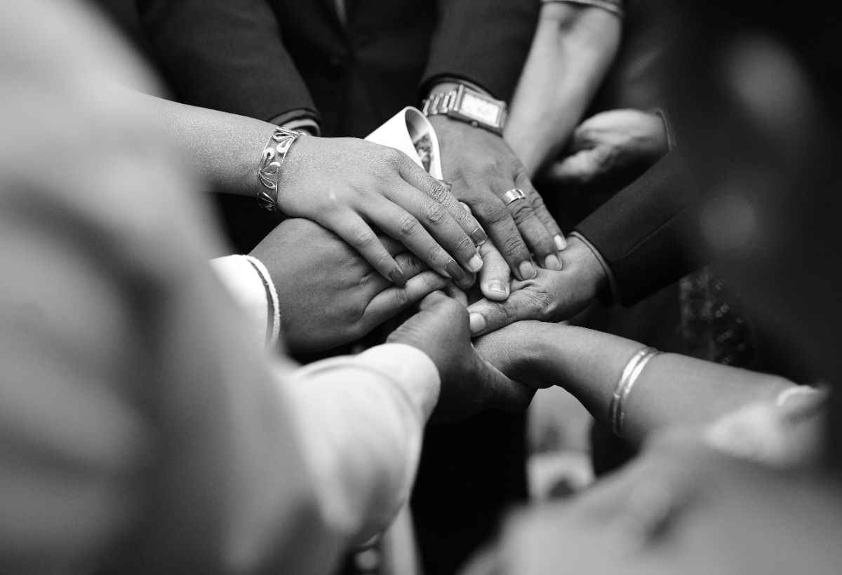 Behavioral-health team members bringing their hands together